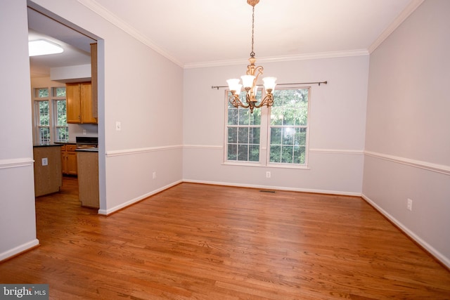 13076 Dove Tree Ct, Manassas, VA 20112 - empty room with a chandelier, light wood-style flooring, plenty of natural light, ornamental molding, and baseboards