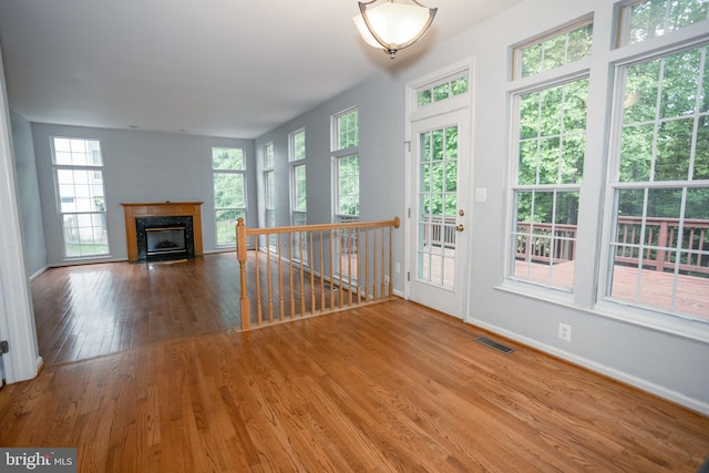 13076 Dove Tree Ct, Manassas, VA 20112 - unfurnished living room with wood finished floors, a premium fireplace, healthy amount of natural light, and baseboards