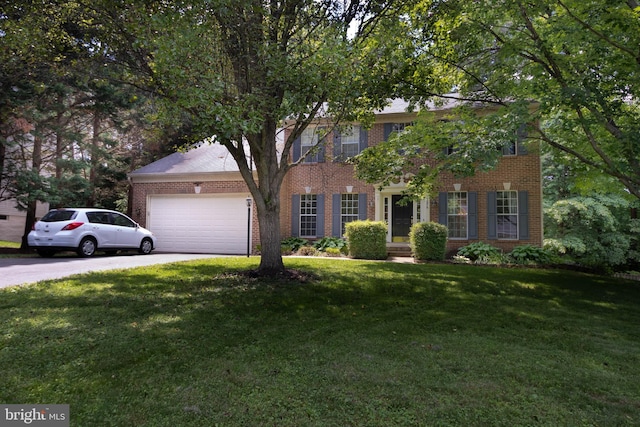 13076 Dove Tree Ct, Manassas, VA 20112 - colonial-style house featuring brick siding, a garage, a front lawn, and driveway