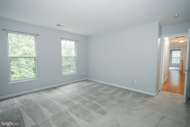 13076 Dove Tree Ct, Manassas, VA 20112 - spare room featuring healthy amount of natural light, baseboards, light colored carpet, and a smoke detector