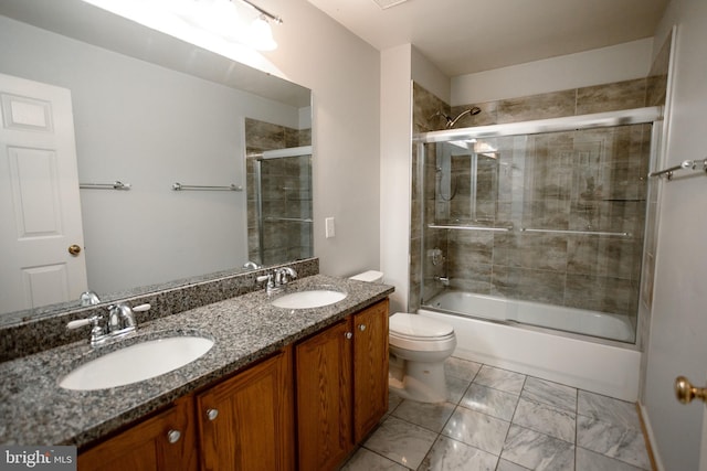13076 Dove Tree Ct, Manassas, VA 20112 - full bathroom with toilet, double vanity, shower / bath combination with glass door, and marble finish flooring