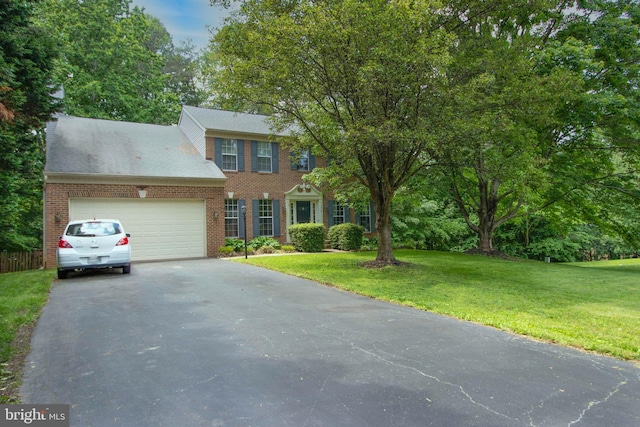 13076 Dove Tree Ct, Manassas, VA 20112 - colonial-style house with asphalt driveway, an attached garage, and brick siding