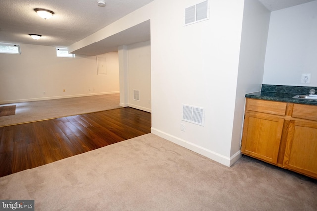 13076 Dove Tree Ct, Manassas, VA 20112 - below grade area with carpet floors, wood finished floors, baseboards, and a sink