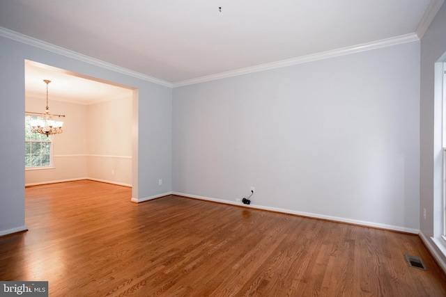 13076 Dove Tree Ct, Manassas, VA 20112 - spare room featuring wood finished floors, a chandelier, baseboards, and ornamental molding