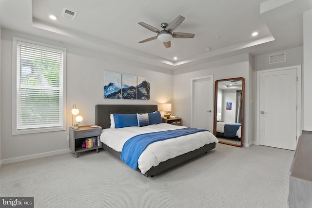 bedroom with a raised ceiling, baseboards, carpet flooring, recessed lighting, and ceiling fan
