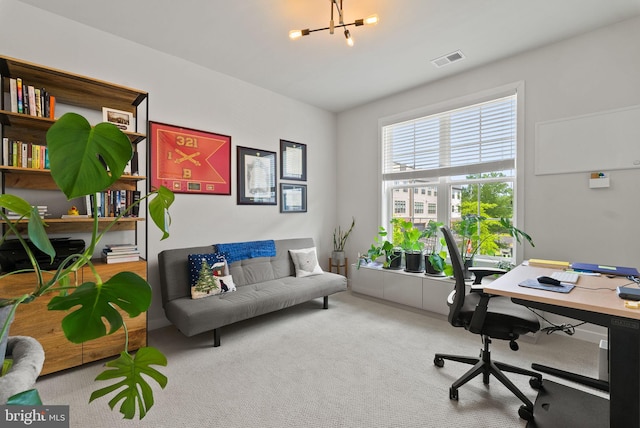 carpeted office space with a chandelier