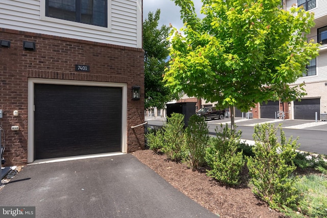 garage with asphalt driveway