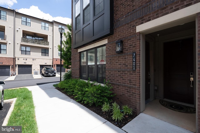 property entrance featuring brick siding