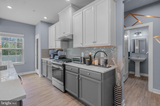 10648 Cheryl Turn, Waldorf, MD 20603 - kitchen featuring stainless steel range with gas cooktop, under cabinet range hood, gray cabinetry, tasteful backsplash, and recessed lighting