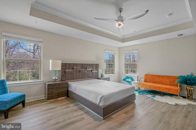 10648 Cheryl Turn, Waldorf, MD 20603 - bedroom featuring a raised ceiling, wood finished floors, and multiple windows
