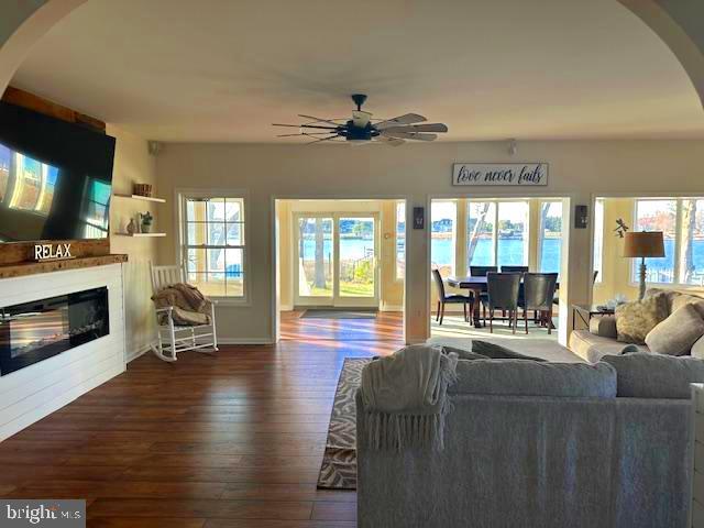 118 Riverview Dr, Dagsboro, DE 19939 - living room with arched walkways, ceiling fan, dark wood finished floors, and plenty of natural light