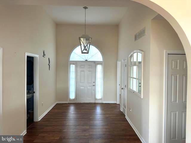 118 Riverview Dr, Dagsboro, DE 19939 - foyer featuring hardwood / wood-style floors, arched walkways, baseboards, and a high ceiling
