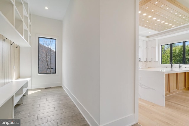 mudroom featuring light wood-style flooring, recessed lighting, and baseboards