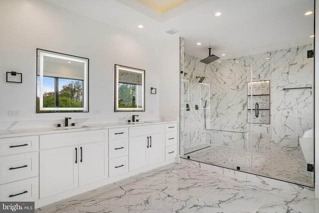 full bath with recessed lighting, a marble finish shower, marble tiled flooring, and double vanity