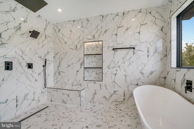 full bath with tile walls, a marble finish shower, a freestanding bath, stone wall, and recessed lighting
