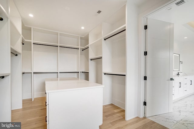 walk in closet featuring light wood finished floors