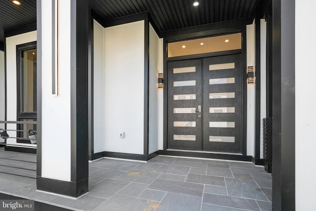 view of exterior entry featuring french doors