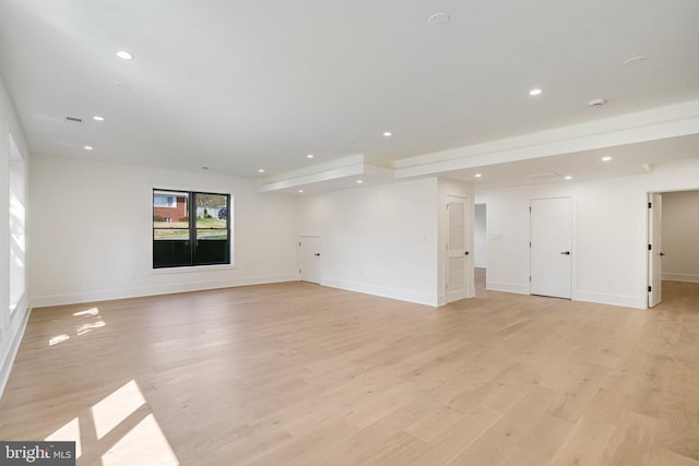 spare room with recessed lighting, baseboards, and light wood finished floors