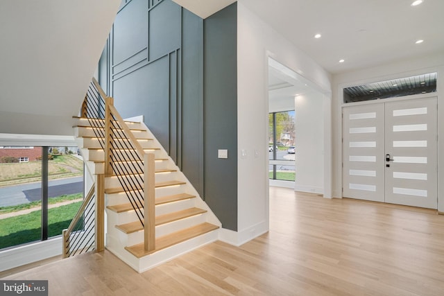 entrance foyer featuring stairway, light wood finished floors, recessed lighting, and baseboards