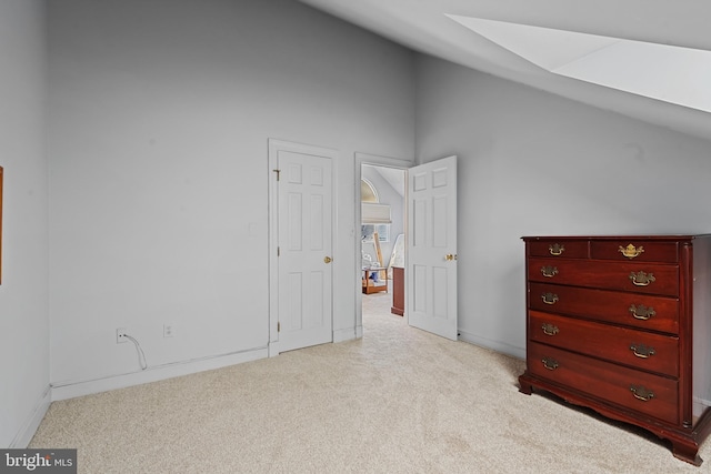 2 Fieldspring Ct, Lutherville Timonium, MD 21093 - bedroom with light carpet, a skylight, baseboards, and high vaulted ceiling