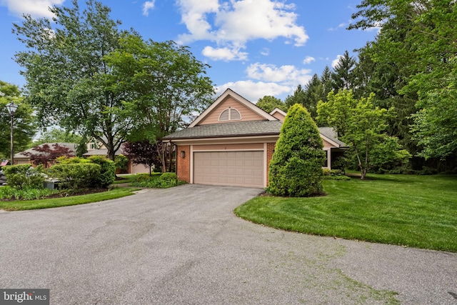 2 Fieldspring Ct, Lutherville Timonium, MD 21093 - view of front facade with brick siding, a front lawn, asphalt driveway, and an attached garage