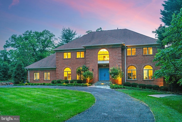 1016 Bellview Rd, Mclean, VA 22102 - colonial-style house featuring a front yard, brick siding, curved driveway, and a chimney