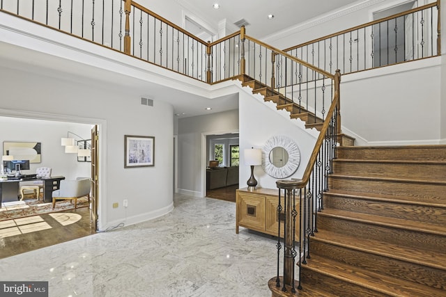 1016 Bellview Rd, Mclean, VA 22102 - staircase featuring crown molding, marble tiled flooring, and a towering ceiling