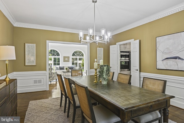 1016 Bellview Rd, Mclean, VA 22102 - dining space featuring a chandelier, crown molding, dark wood-style floors, and wainscoting