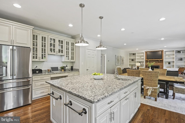 1016 Bellview Rd, Mclean, VA 22102 - kitchen with stainless steel refrigerator with ice dispenser, a fireplace, open floor plan, an island with sink, and glass insert cabinets