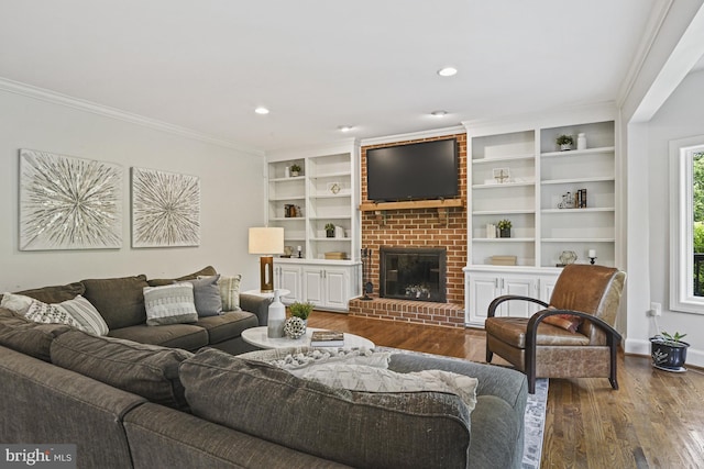 1016 Bellview Rd, Mclean, VA 22102 - living area with wood finished floors, crown molding, a brick fireplace, recessed lighting, and built in shelves