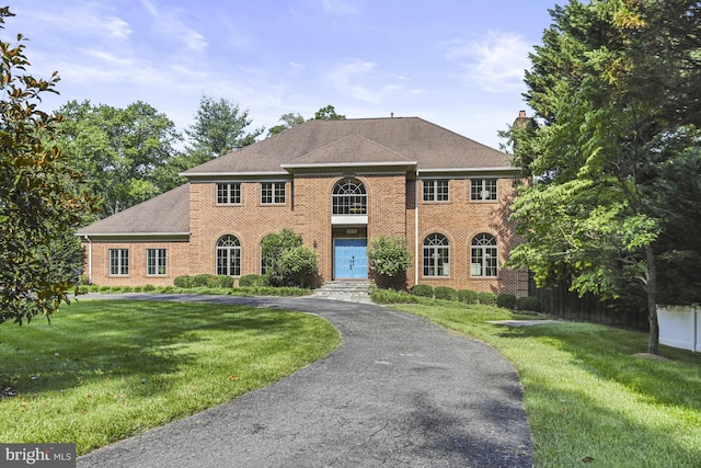 1016 Bellview Rd, Mclean, VA 22102 - colonial inspired home featuring brick siding, a front yard, asphalt driveway, and a chimney