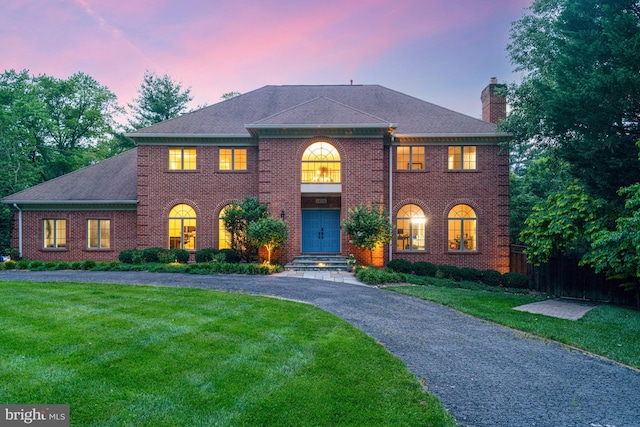 1016 Bellview Rd, Mclean, VA 22102 - colonial-style house with a chimney, a front lawn, brick siding, and driveway