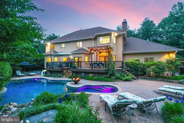 1016 Bellview Rd, Mclean, VA 22102 - rear view of house featuring a wooden deck, a chimney, stairway, and a patio
