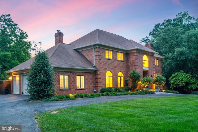 1016 Bellview Rd, Mclean, VA 22102 - colonial home featuring a chimney, driveway, a lawn, brick siding, and an attached garage