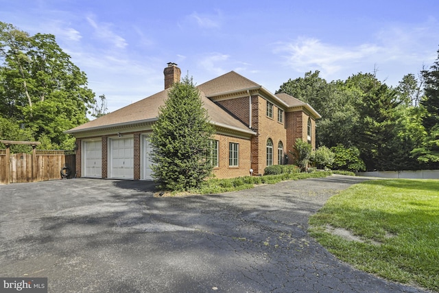 1016 Bellview Rd, Mclean, VA 22102 - view of property exterior featuring brick siding, a chimney, and asphalt driveway