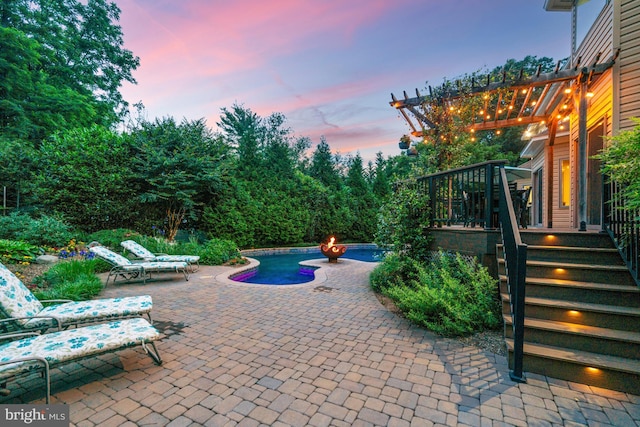 1016 Bellview Rd, Mclean, VA 22102 - patio terrace at dusk featuring a patio and an outdoor fire pit