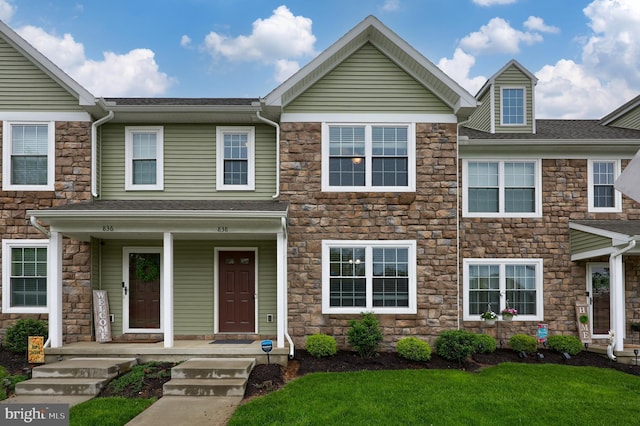 838 Byler Cir, Lebanon, PA 17042 - townhome / multi-family property featuring stone siding, covered porch, and a front lawn