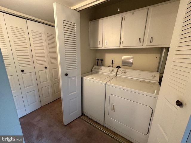 washroom with washing machine and dryer, cabinet space, and dark carpet
