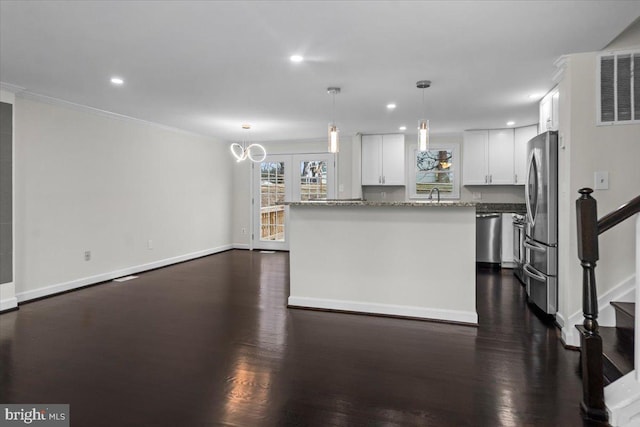 6867 Happyheart Ln, Columbia, MD 21045 - kitchen with appliances with stainless steel finishes, white cabinets, baseboards, dark wood finished floors, and crown molding
