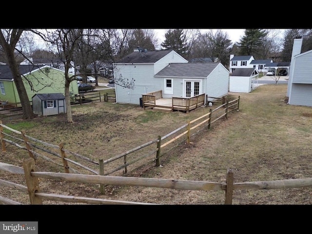 6867 Happyheart Ln, Columbia, MD 21045 - fenced backyard with a storage shed, a wooden deck, and an outbuilding