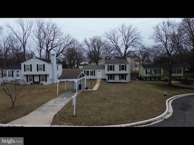 6867 Happyheart Ln, Columbia, MD 21045 - tri-level home with driveway, a carport, a front yard, and a residential view