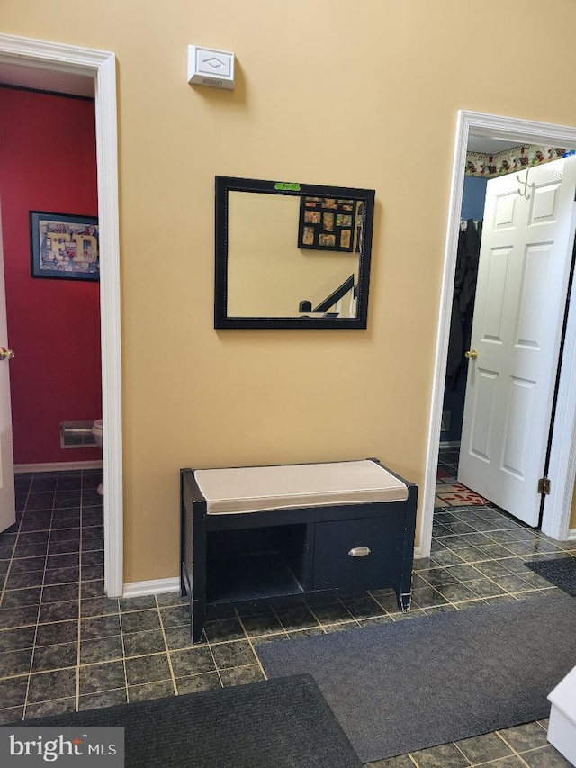 hall featuring baseboards