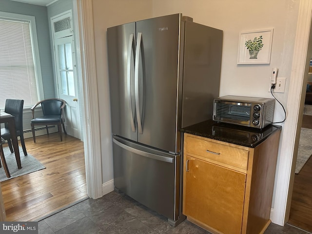 313 E Cherry St, Palmyra, PA 17078 - kitchen featuring freestanding refrigerator, baseboards, dark wood-style floors, and dark stone counters