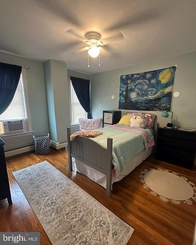 313 E Cherry St, Palmyra, PA 17078 - bedroom with baseboard heating, cooling unit, wood finished floors, and a ceiling fan