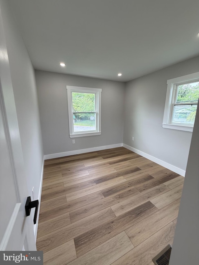 8110 Manson St, Landover, MD 20785 - empty room with plenty of natural light, wood finished floors, recessed lighting, and baseboards