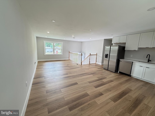 8110 Manson St, Landover, MD 20785 - kitchen featuring stainless steel appliances, a sink, recessed lighting, light wood-style floors, and white cabinetry