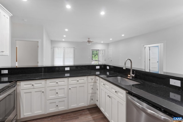 6169 Community House Rd, Columbia, VA 23038 - kitchen featuring stainless steel appliances, a sink, dark stone countertops, dark wood-style floors, and white cabinetry