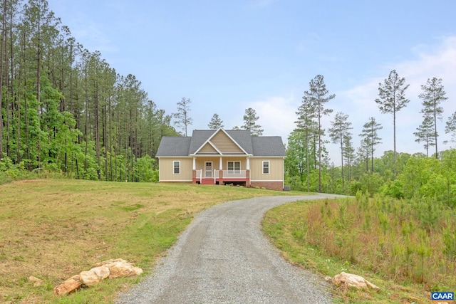 6169 Community House Rd, Columbia, VA 23038 - view of front of house featuring gravel driveway, a front yard, a porch, and a view of trees