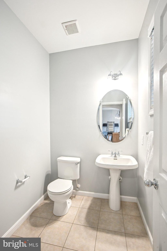 34637 Megan Ct, Lewes, DE 19958 - half bathroom featuring tile patterned floors, toilet, and baseboards