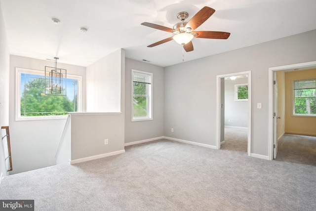 34637 Megan Ct, Lewes, DE 19958 - empty room with carpet flooring, baseboards, ceiling fan, and a chandelier